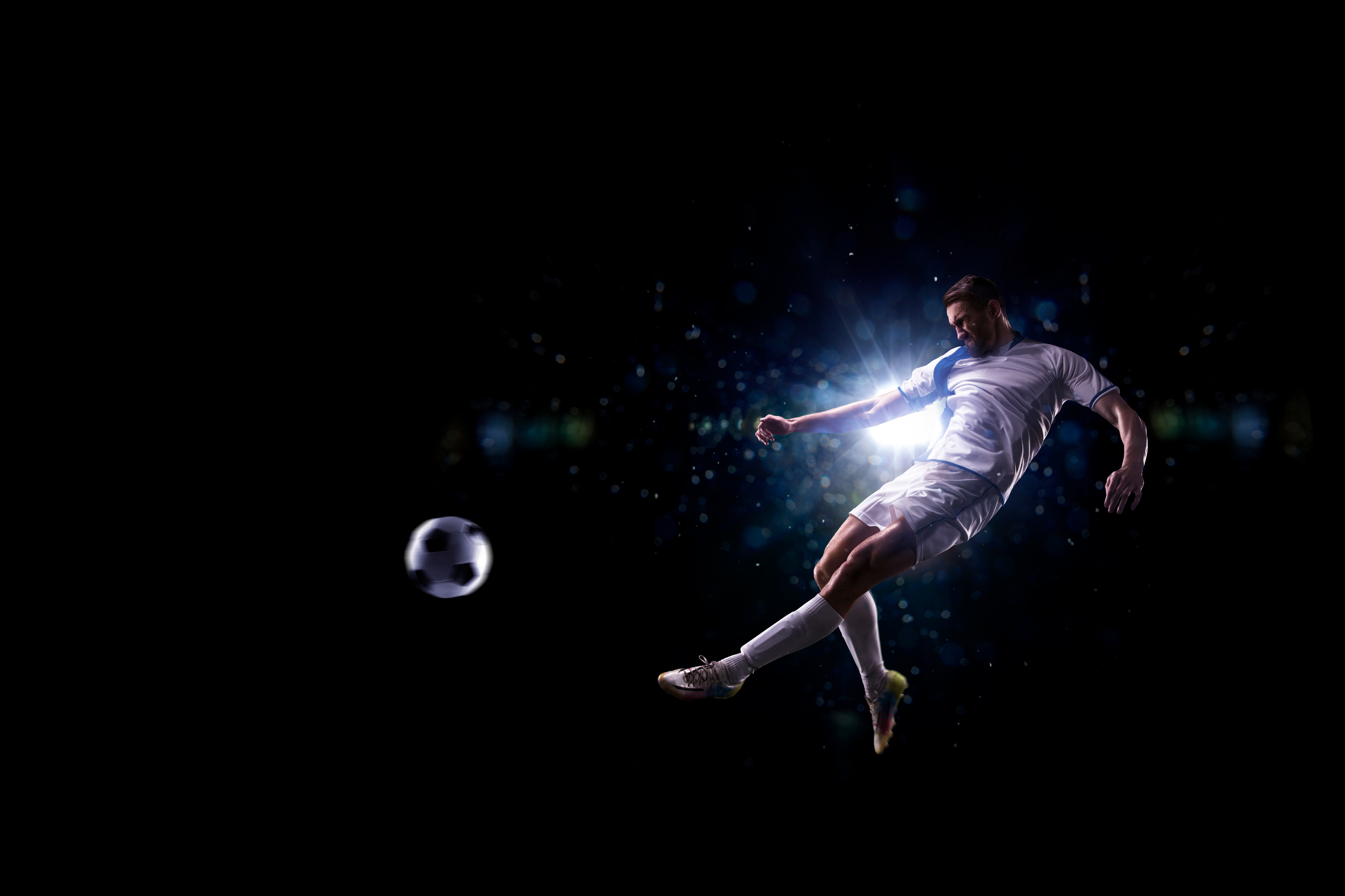Soccer player in action over black background
